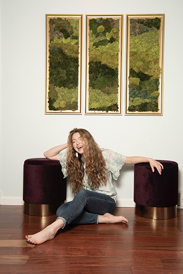 blond smiling woman sitting on floor